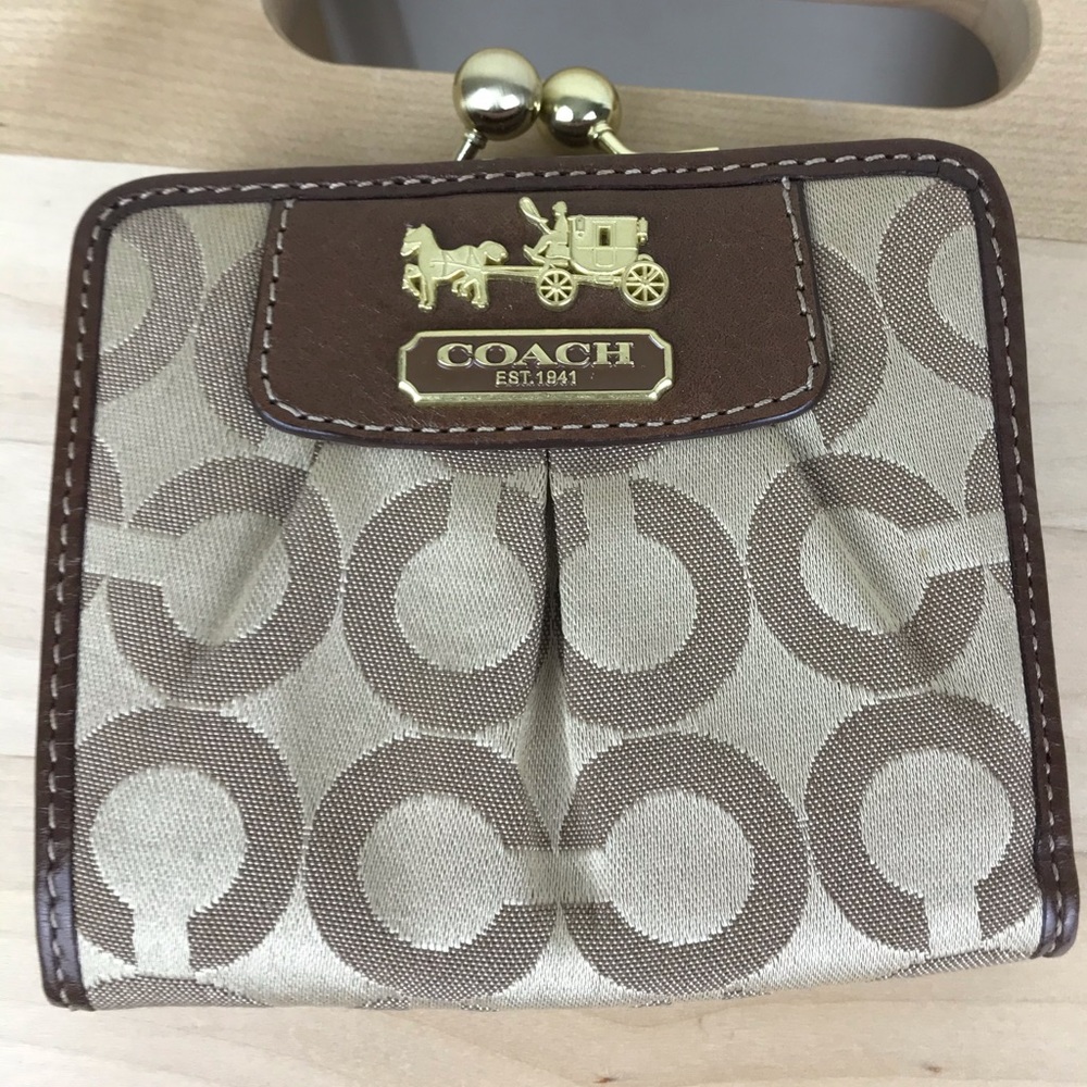 NWOT Coach bifold wallet with pink interior.